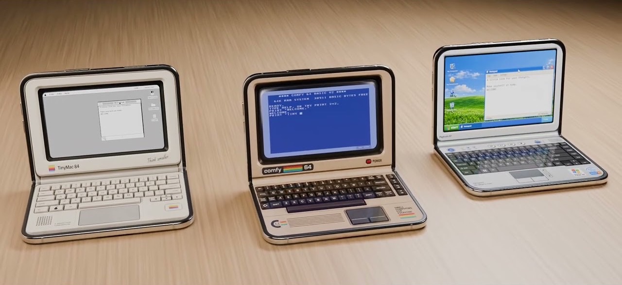 Three miniature computers on a wooden desk: a TinyMac 84, a Comfy 64 showing BASIC, and a Windows XP style laptop.